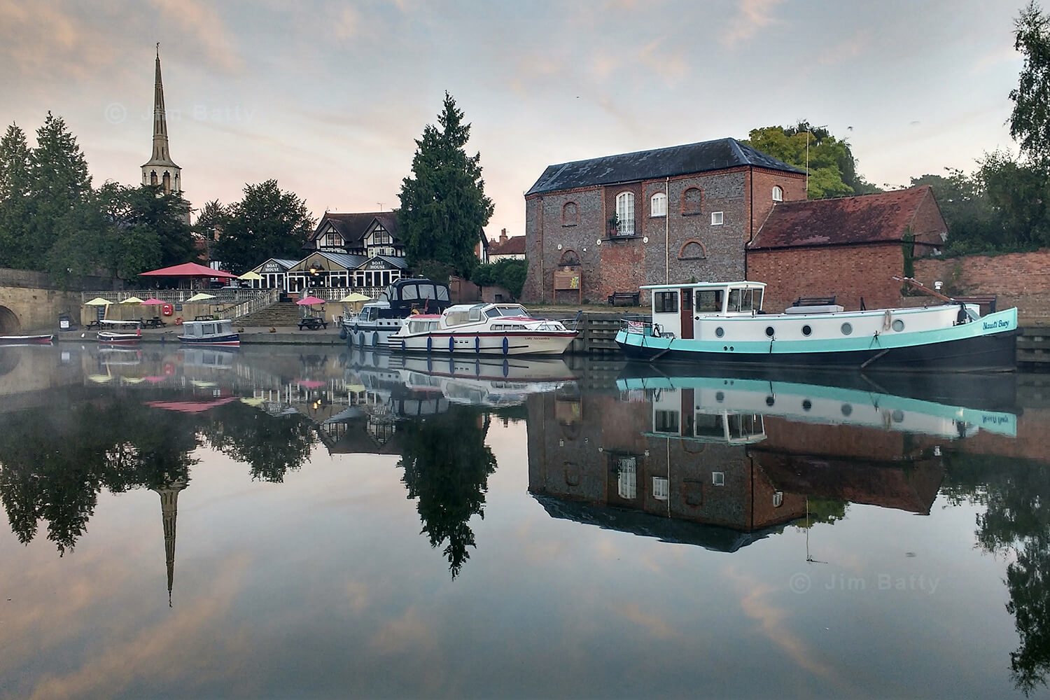 A Dutch barge, cruisers and small day boats moored on the River Thames at Wallingford