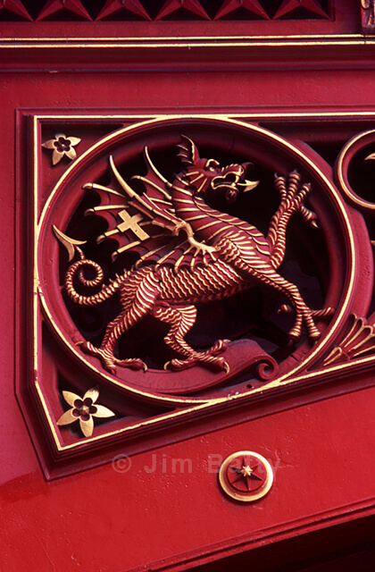 Red dragon rampant piqued out with gold linework - detail of ornamented ironwork on Holborn Viaduct