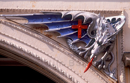 Crouching dragon above archway at Smithfield Market Crouching dragon on corner of overhead archway, Smithfield Market, City of London
