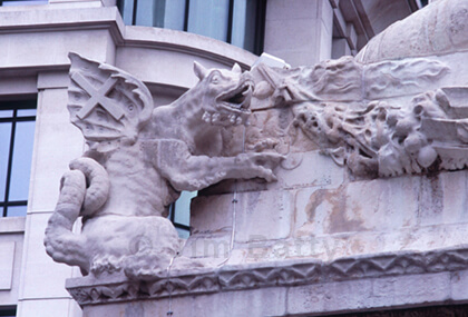 Monument Dragon Stone dragon crouching above on the corner of Monument