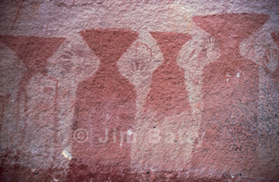 Ancient cliff art: group of triange-headed figures and hand silhouettes at Pha Taem, Northeast Thailand