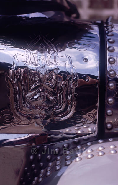 Buddhist motif hammered into truck metalwork, NE Thailand Buddhist motif: Ornamental hammered metalwork on a truck in Northeast Thailand